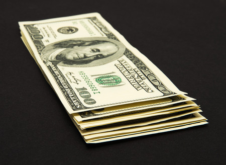 Dollars banknotes isolated on black background.の写真素材