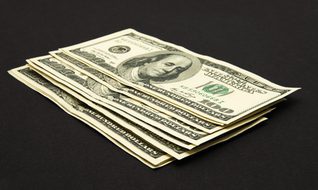 Dollars banknotes isolated on black background.の写真素材