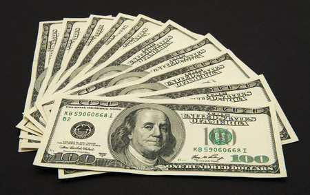 Dollars banknotes isolated on black background.の写真素材
