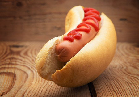 Tasty hot dog on wooden tableの写真素材