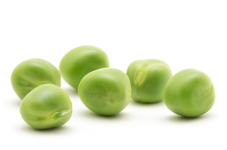 fresh green peas isolated on a white backgroundの写真素材