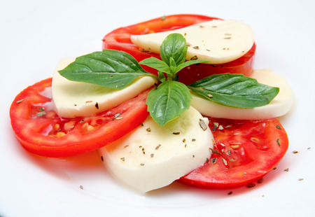 Caprese salad with mozarella cheese, tomatoes and basilの写真素材