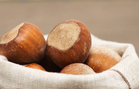 Closeup view of hazelnuts on a wooden tableの写真素材