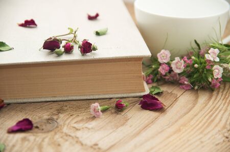 Dry roses and old book. Toned imageの写真素材