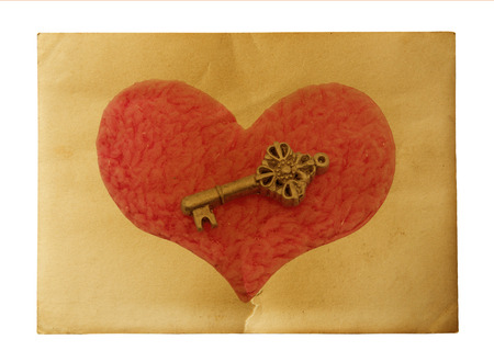 Key with the heart as a symbol of love/vintage card with red heart on grunge old background/valentin es day backgroundの写真素材
