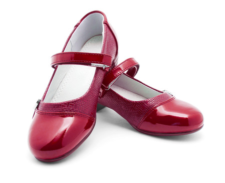 Red shine leather girl shoes isolated on whiteの写真素材