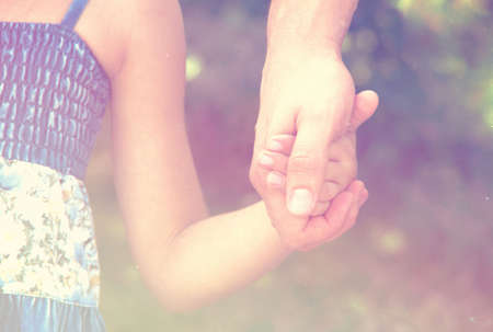 father holding  daughter hand filteredの写真素材