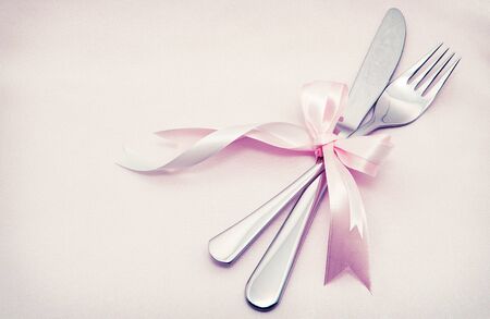 White plate, fork and knife on light background.の写真素材