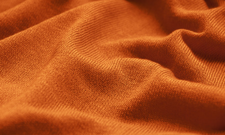 The texture of a knitted woolen fabric orange.の写真素材