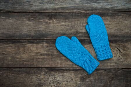 Winter Gloves on a Wooden Backgroundの写真素材
