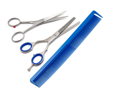 Scissors and hairbrush isolated on white