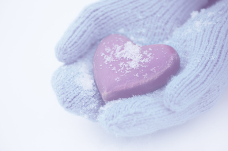 Female hands in mittens with heart, close-upの写真素材