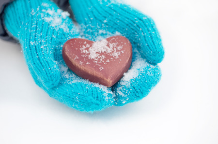 Female hands in mittens with heart, close-upの写真素材