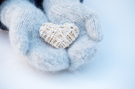 Female hands in mittens with heart, close-upの写真素材