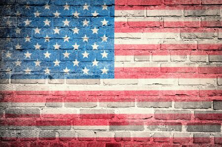 Grunge USA flag on brick wall backgroundの写真素材