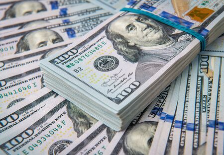Stack of one hundred dollar bills close-up.