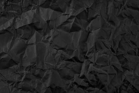 Black crumpled paper texture background.の写真素材