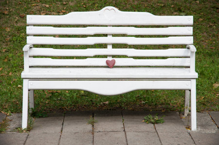 Wooden white bench in a parkの写真素材