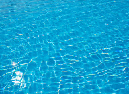 surface of blue swimming pool, background of water in swimming pool.の写真素材