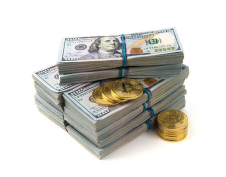 Bitcoin gold coins on US dollar bills.の写真素材