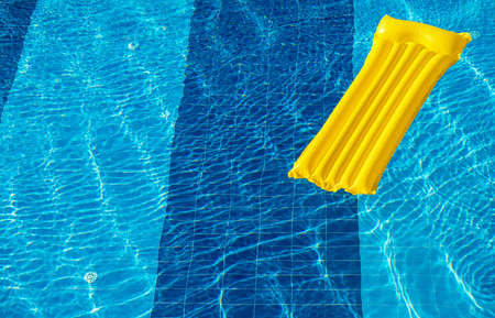 Air Yellow Mattress On The Water In The Poolの写真素材