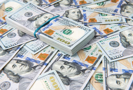 Stack of one hundred dollar bills close-up.の写真素材