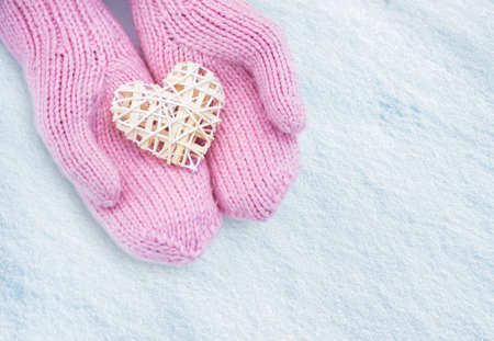 Female hands in mittens with heart, close-upの写真素材