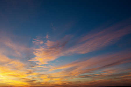 Vivid sky illuminated by the sunsetの写真素材