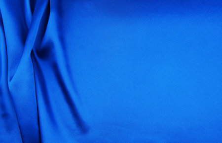 Blue satin or silk fabric as backgroundの写真素材