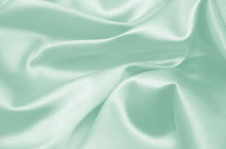 Smooth elegant green silk can be used as backgroundの写真素材