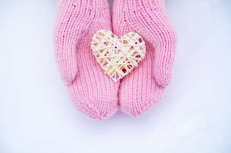 Female hands in mittens with heart, close-upの写真素材