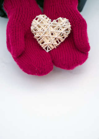 Female hands in mittens with heart, close-upの写真素材