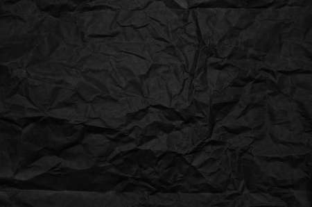 Crumpled black paper for background usageの写真素材