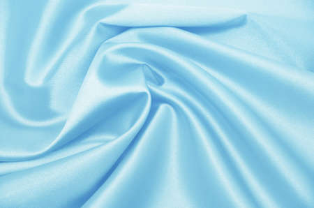 Smooth elegant blue silk can be used as backgroundの写真素材