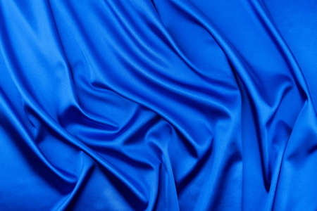 Blue satin or silk fabric as backgroundの写真素材