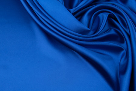 Blue satin or silk fabric as backgroundの写真素材