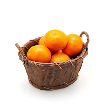 Mandarin in basket isolated on whiteの写真素材