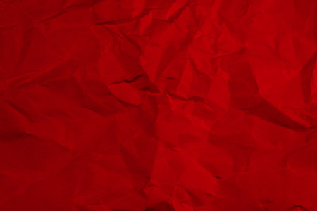 Red crumpled paper texture background.の写真素材