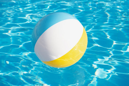 Colorful inflatable ball floating in swimming poolの写真素材