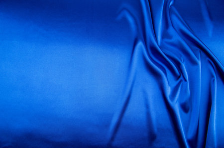 Blue satin or silk fabric as backgroundの写真素材