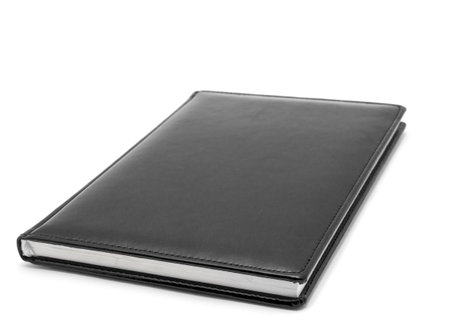 Black diary on a white backgroundの写真素材
