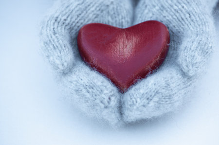 Female hands in mittens with heart, close-upの写真素材