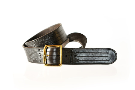 Dark belt with buckle isolated on white. Leather products.の写真素材