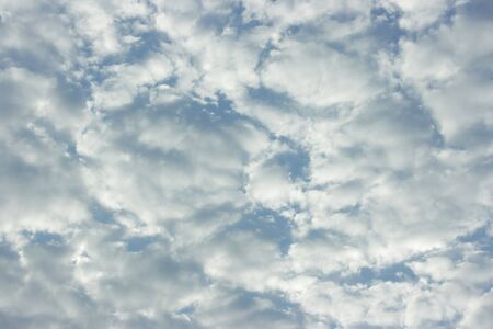 Many soft clouds of pearl tint on the sky of color blue pastel