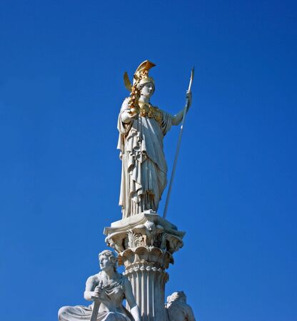 White marble statue of Athena, Greek goddess of war, in Vienna. Isolated over blue skyの写真素材