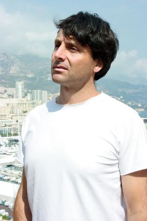 Thoughtful man with a city landscape on the backgroundの写真素材