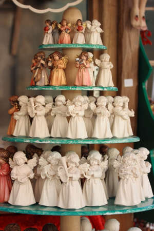 Souvenir angels of different size, colored and white for saleの写真素材