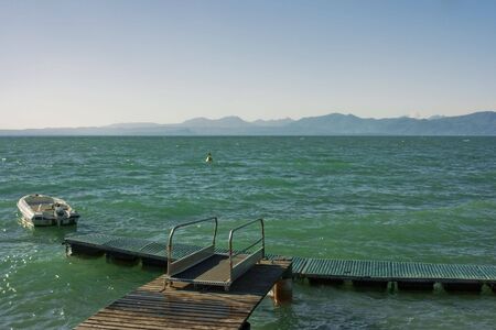 Beautiful view on Garda lake with mountains on horizonの写真素材