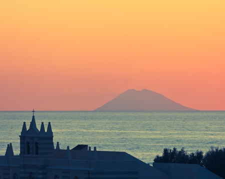 View in Tropea on Stromboli vulcano during sunset over mediterranean seaの写真素材