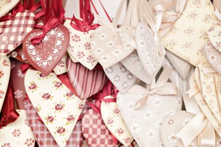 Shabby chic handmade hearts of fabric in vanilla-creamy toning. Focus on the central part of picture